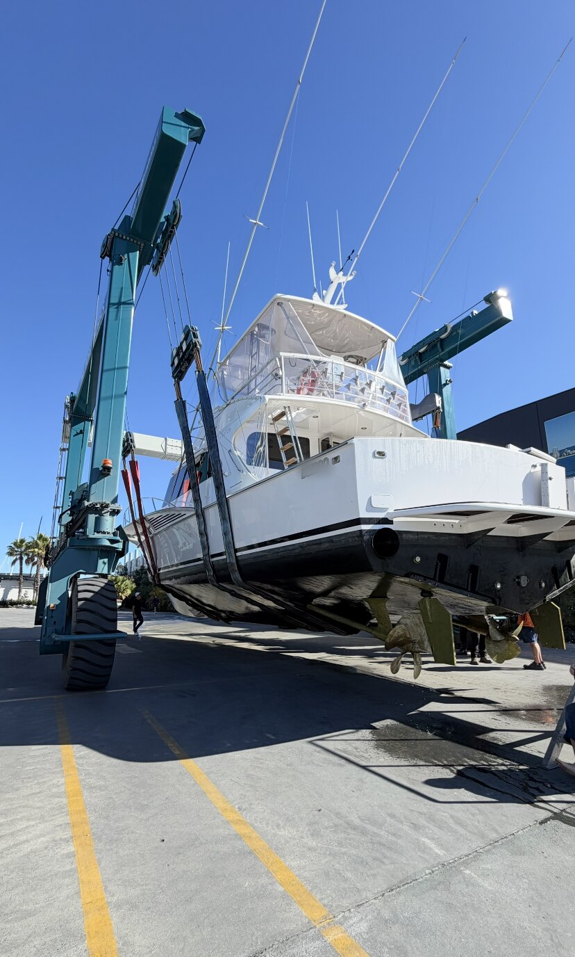 Sportfishing vessel positioned in a travel lift during a managed haul-out